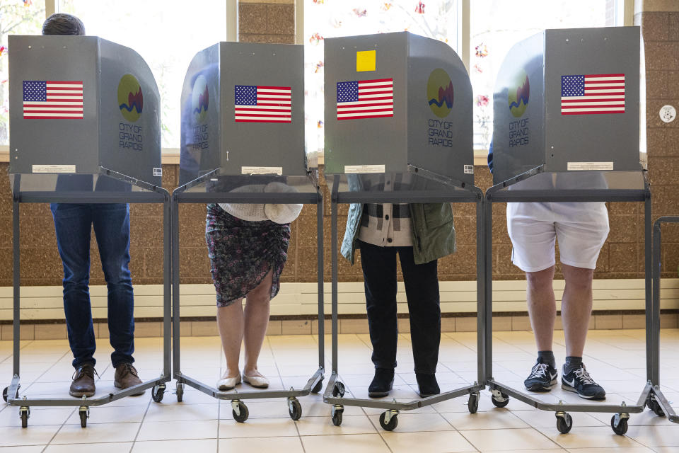 FILE - People cast their ballots at Coit Arts Academy in Grand Rapids on Tuesday, Nov. 8, 2022. On a successful, high-profile ballot measure in the battleground state of Michigan, proposing to enshrine abortion rights in the state constitution, Catholic voters split about evenly, according to AP VoteCast, an expansive survey of more than 94,000 voters across the country. (Joel Bissell/The Grand Rapids Press via AP, File)