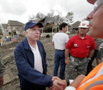 <p>Sen. John McCain shakes hands with Army Corps of Engineers structural engineer Fred Young far right, near the break of the 17th Street canal levee in the Lakeview area of New Orleans on Friday, March 10, 2006. (Photo: Alex Brandon/AP) </p>