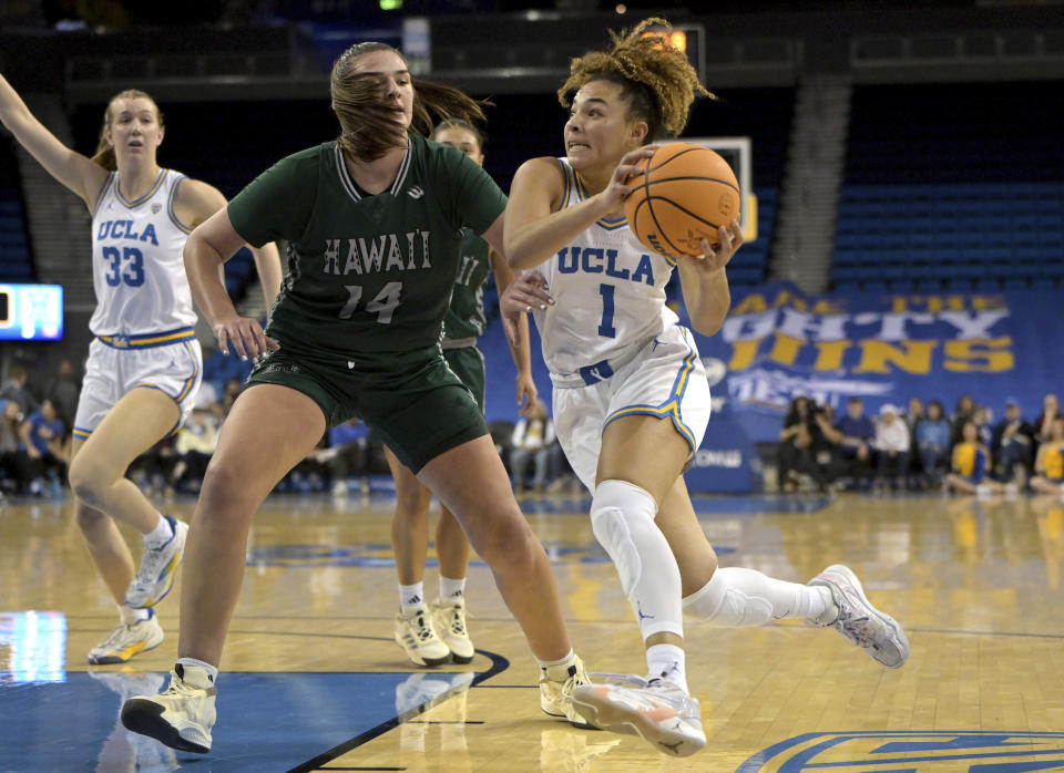 UCLA's Kiki Rice drives past Hawaii Brooklyn Rewers (14) for a basket during the first half of an NCAA college basketball game Thursday, Dec. 21, 2023, in Los Angeles. (AP Photo/Jayne Kamin-Oncea)