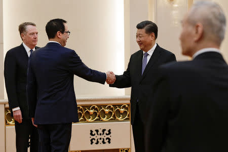 U.S. Treasury Secretary Steven Mnuchin shakes hands with Chinese President Xi Jinping as U.S. Trade Representative Robert Lighthizer, left, and Chinese Vice Premier Liu He, right, look on before proceeding to their meeting at the Great Hall of the People in Beijing, China February 15, 2019. Andy Wong/Pool via REUTERS