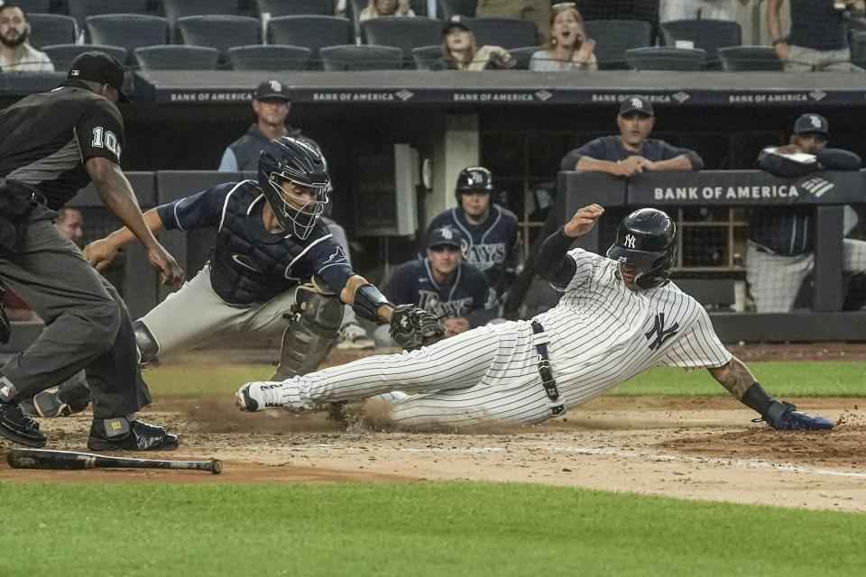 New York Yankees second baseman Gleyber Torres (25) slides home for the second run during the fourth inning of a baseball game against the Tampa Bay Rays, Tuesday June 14, 2022, in New York. (AP Photo/Bebeto Matthews)