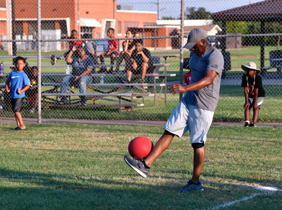 Abilene Police Chief Marcus Dudley plays kickball during a game at the 2021  Juneteenth celebration at Stevenson Park.