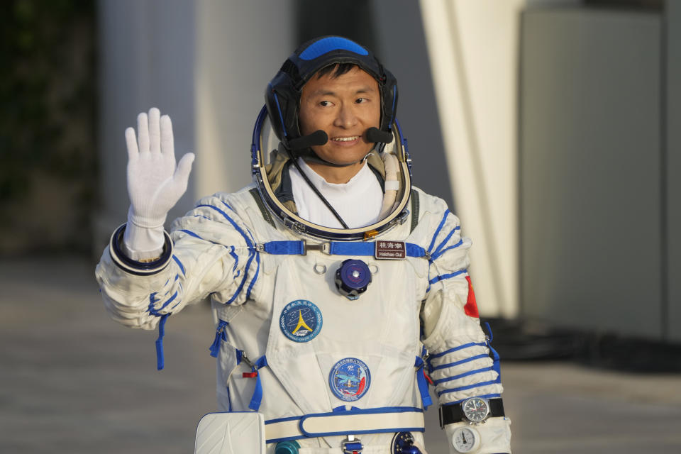 Chinese astronaut Gui Haichao waves during a send-off ceremony for his manned space mission at the Jiuquan Satellite Launch Center in northwestern China, Tuesday, May 30, 2023. (AP Photo/Mark Schiefelbein)