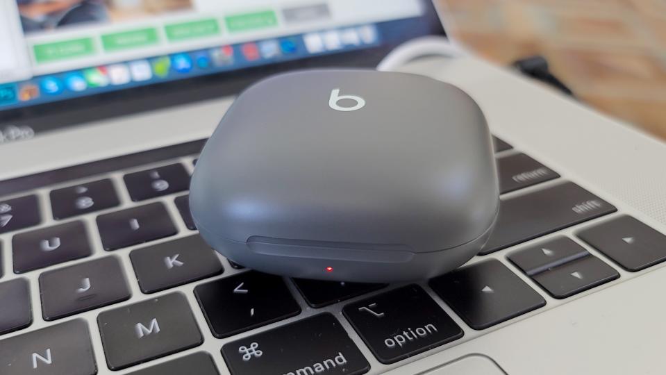 The Beats Fit Pro charging on a MacBook Pro