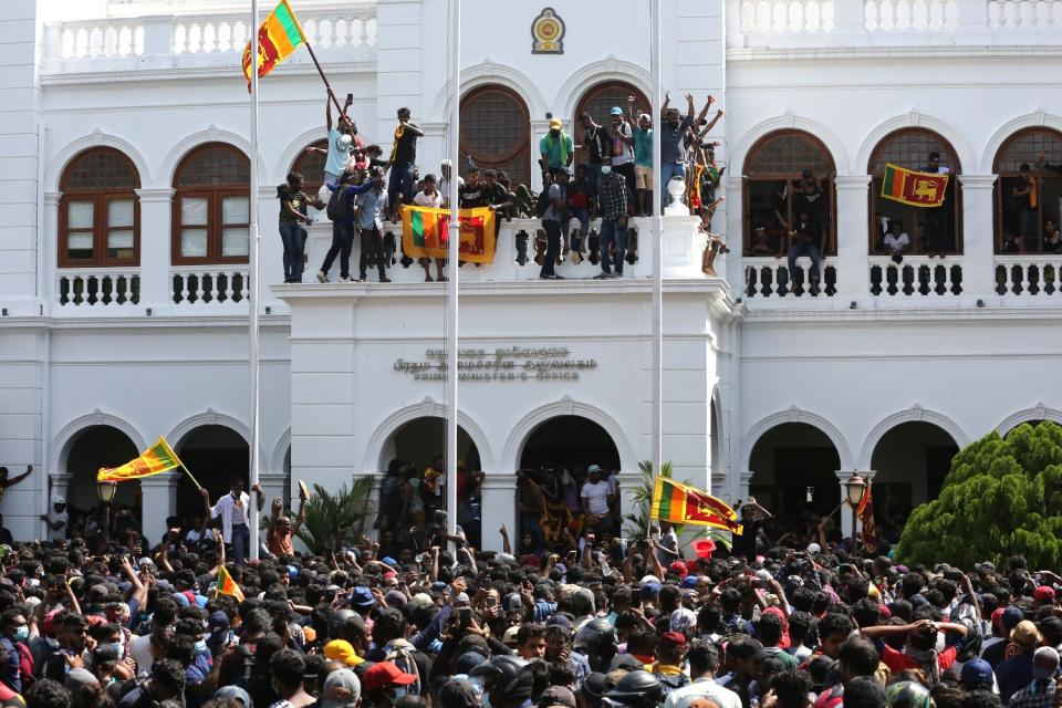 Protesters celebrate after they stormed the Prime Minister's office in Colombo, Sri Lanka