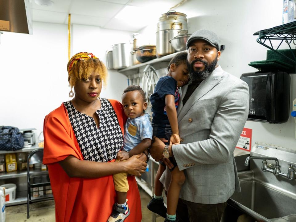 Two Atlanta CloudKitchens operators, Anita and Chudi Orubele,hold their children