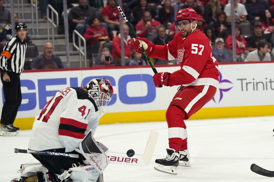 New Jersey Devils goaltender Vitek Vanecek (41) deflects a shot by Detroit Red Wings left wing David Perron (57) during the second period of an NHL hockey game, Tuesday, Oct. 25, 2022, in Detroit. (AP Photo/Carlos Osorio)