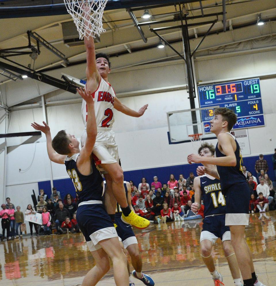 Heritage's Jackson Cline (2) attempts a finger roll as Shalom's Andrew Schmidt (33) defends during the Mason Dixon Christian Conference boys basketball tournament final.