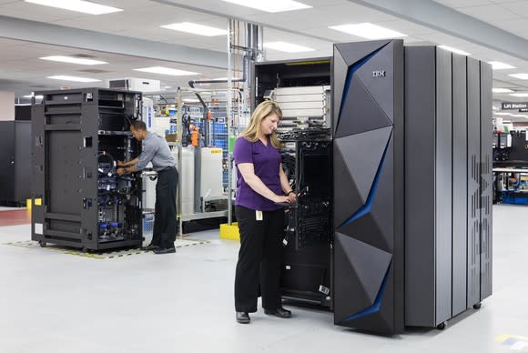 Employees working on two IBM z14 mainframe systems.