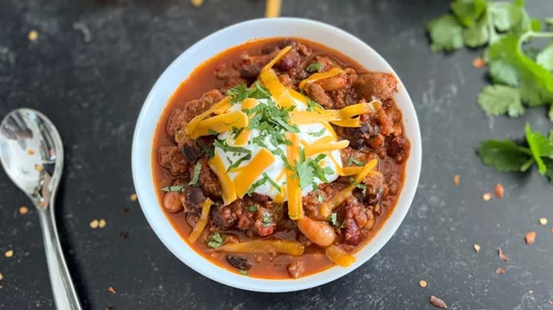 beer chili with sour cream, cheese, and cilantro