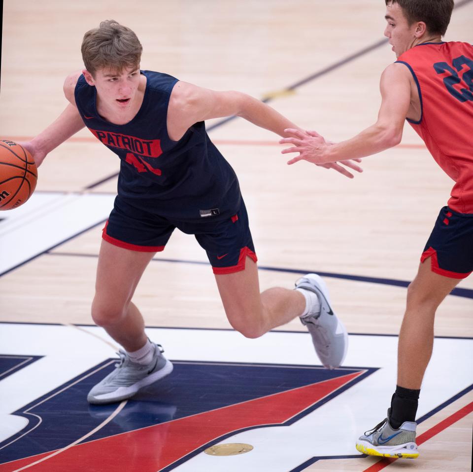 Trent Sisley, left, is guarded by Charlie Brentlinger during their practice at Heritage Hills High School Wednesday evening, Nov. 17, 2021. Sisley, a freshman, has received an offer to play basketball for Purdue before he has even played one game in high school.