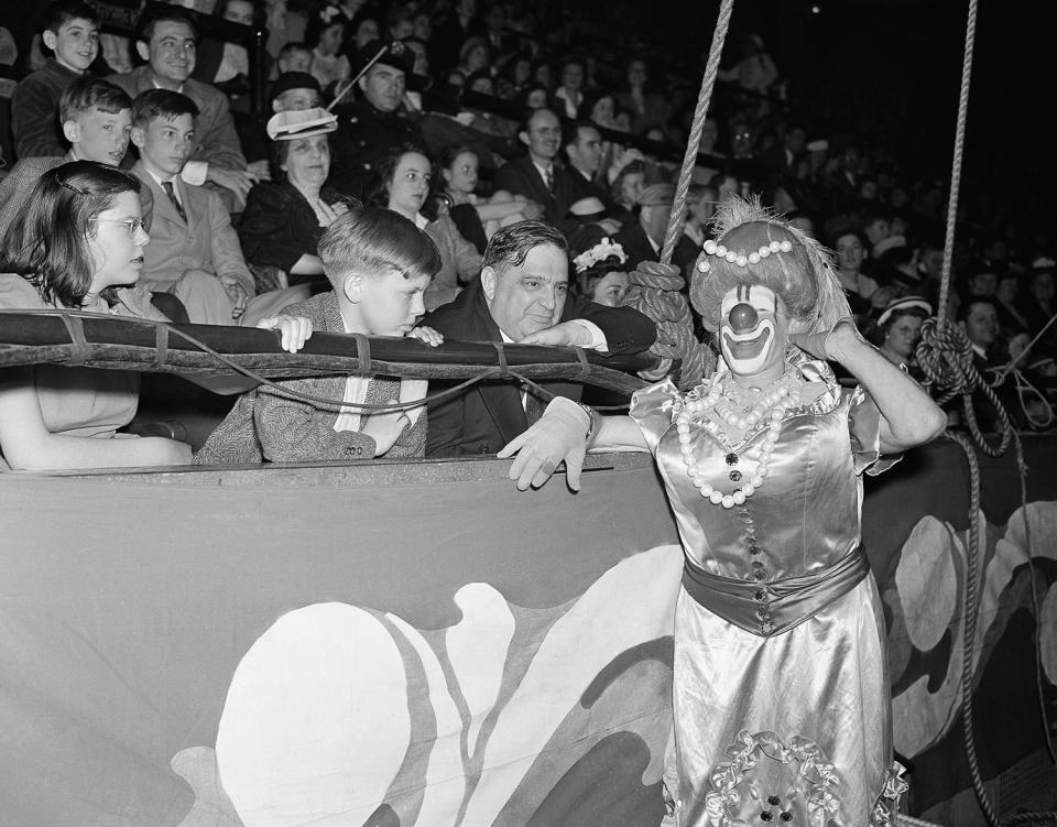 <p>Mayor Fiorello La Guardia and his children, Jean, left, and Eric, pictured with one of the circus clowns, Lew Jacobs, as they watched the big show in Madison Square Garden, New York on April 25, 1942. A good time was had by all. (AP Photo/RW) </p>