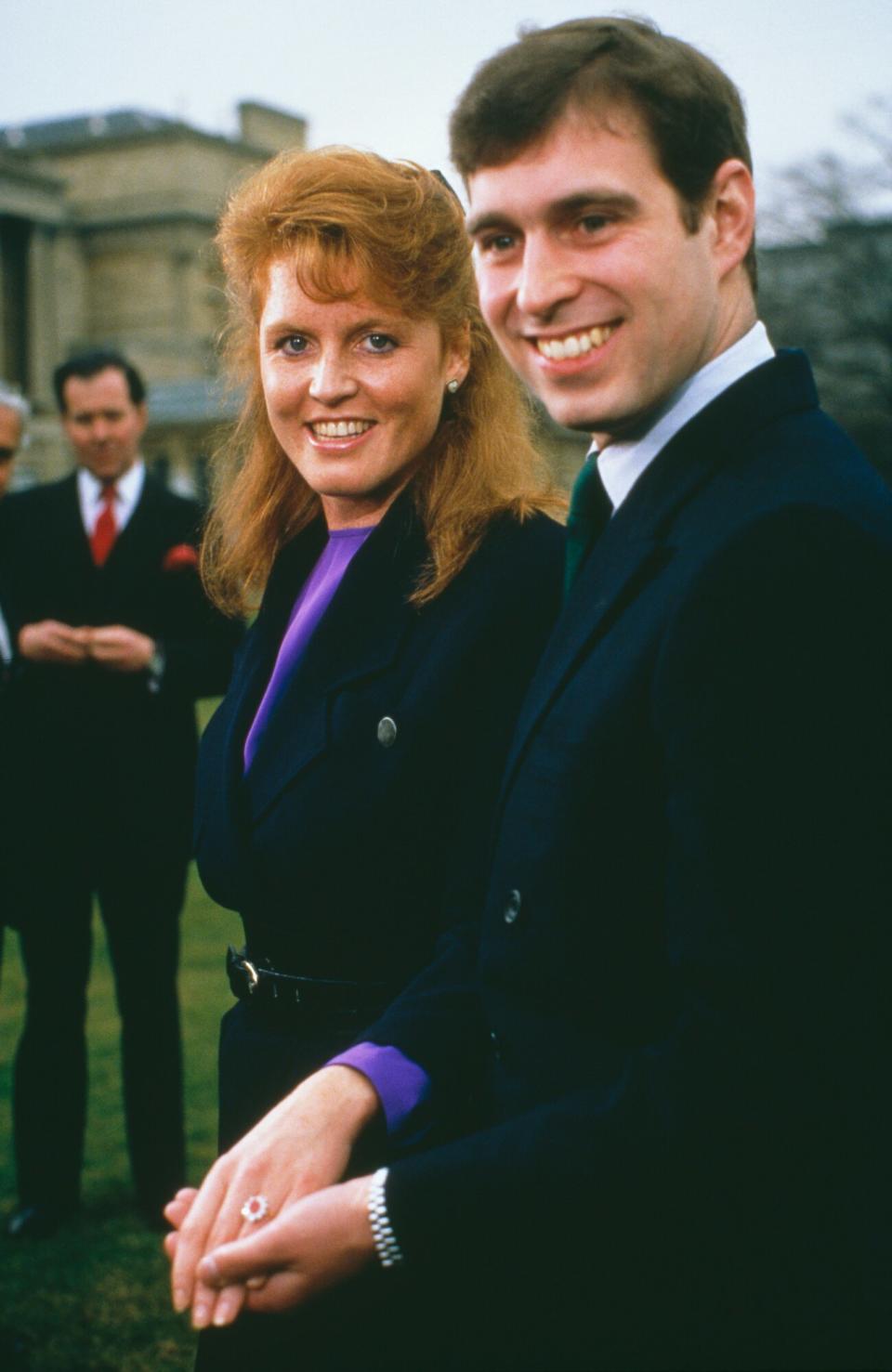 Prince Andrew with Sarah Ferguson at Buckingham Palace after the announcement of their engagement, London, 17th March 1986. Ferguson's white and yellow gold engagement ring features a Burma ruby, surrounded by ten drop-diamonds