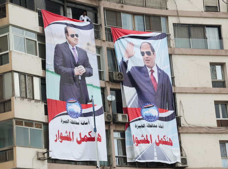 Supports of al-Sisi attend a rally to back his candidacy in the presidential elections, in Giza