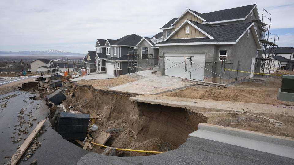 Local officials issued evacuation orders for at least 20 homes as temperatures spiked and snowmelt coursed through the streets on Wednesday, April 12, 2023, in Kaysville, Utah. A record-breaking snow season has raised fears of spring flooding throughout Utah as the weather in mountain regions warms. (AP Photo/Rick Bowmer)