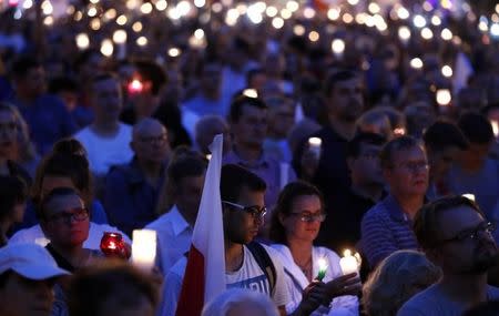 People hold candles during a protest against supreme court legislation in Warsaw, Poland, July 21, 2017. REUTERS/Kacper Pempel