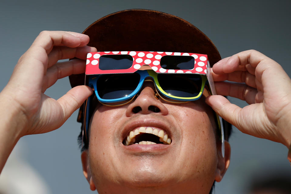 A man watches a partial solar eclipse at the Canada Aviation and Space Museum in Ottawa, Ontario, Canada, August 21, 2017. REUTERS/Chris Wattie