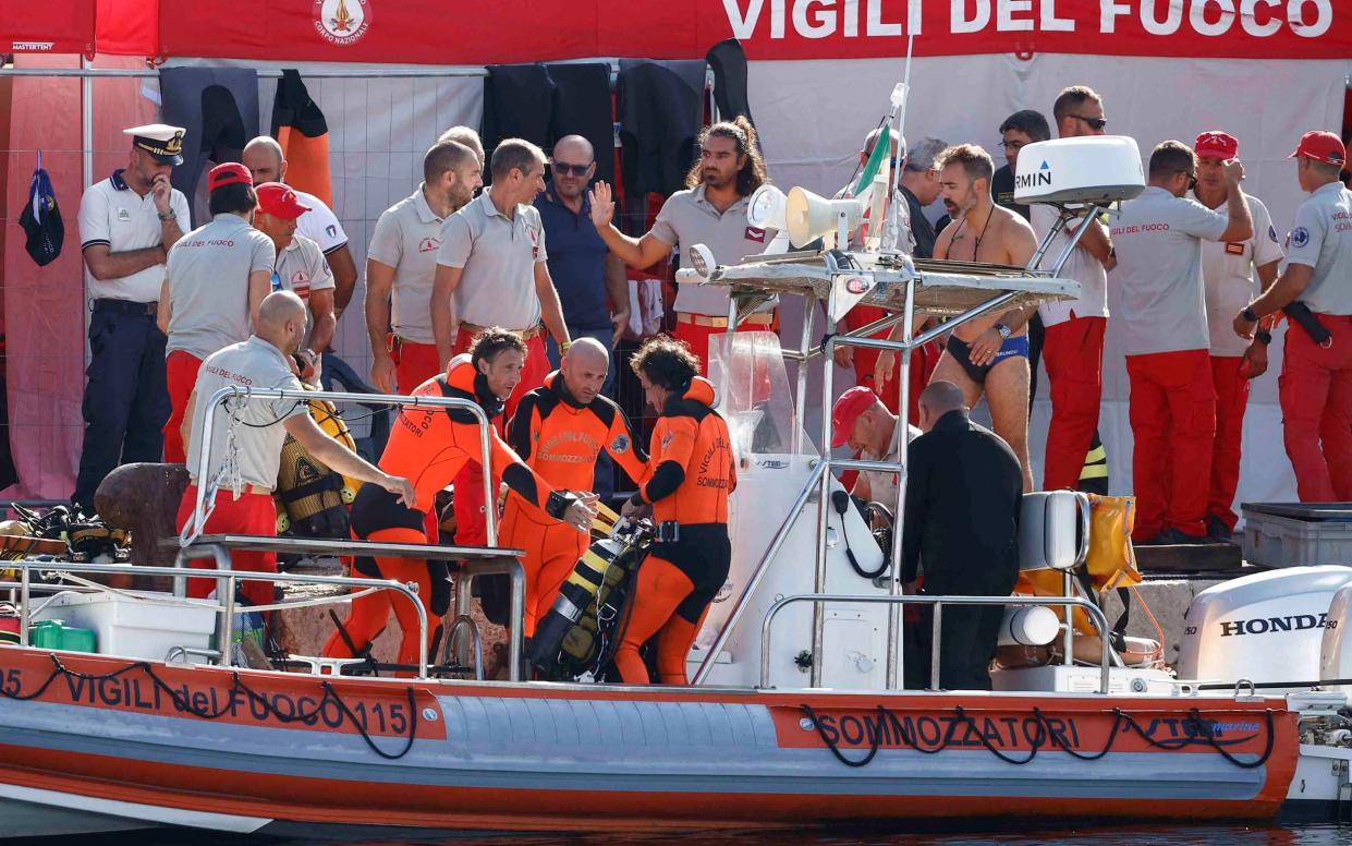 Rescue personnel operate at a port to search for survivors