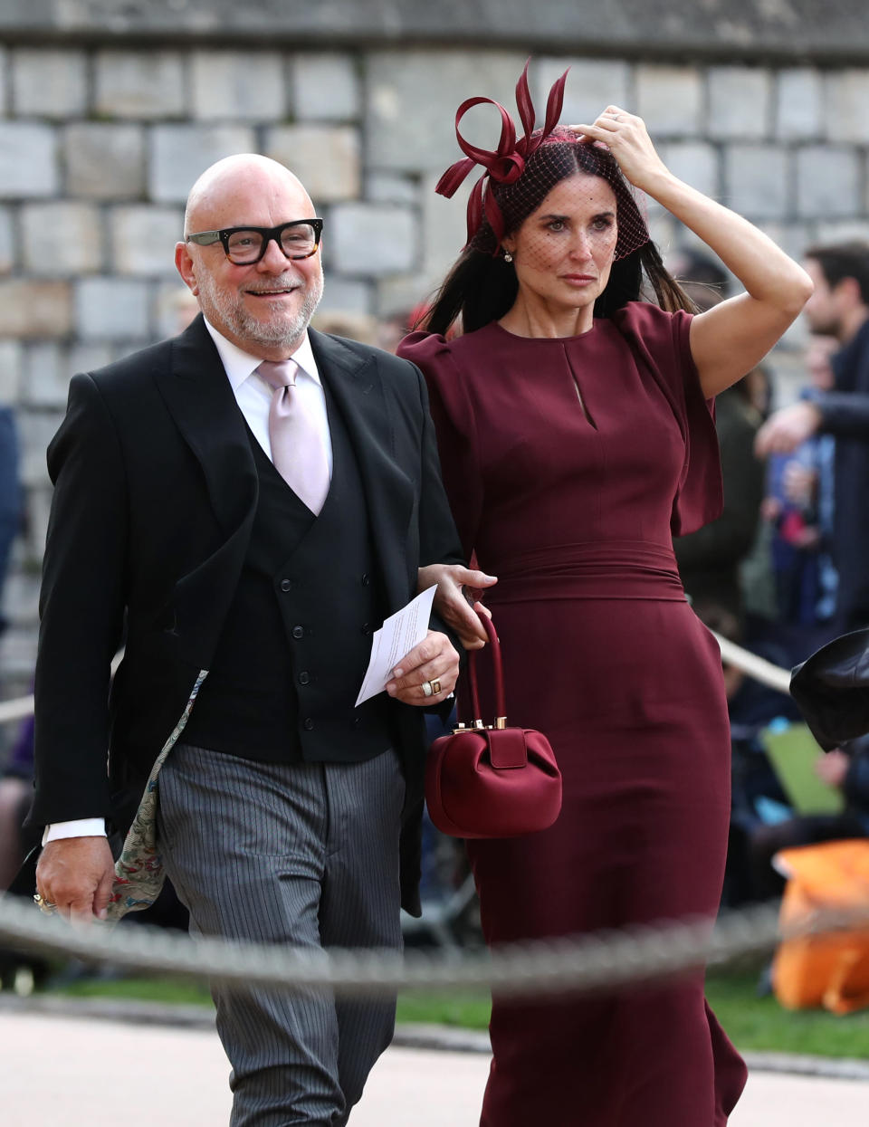 <p>Actress Demi Moore kept up the autumn theme in a plum-coloured dress by Malone Souliers and co-ordinating fascinator. <em>[Photo: Getty]</em> </p>