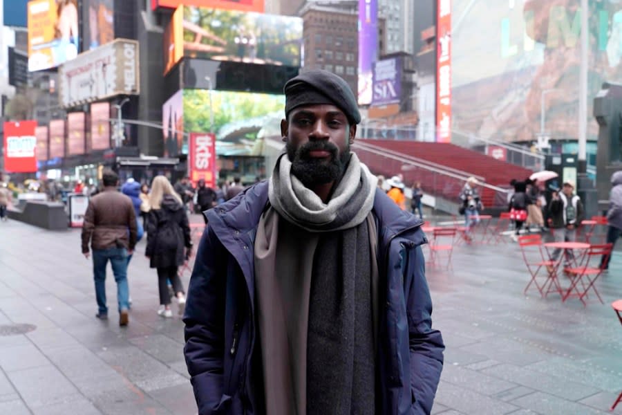 In this screen grab taken from video, Tunde Onakoya, 29- years old, a Nigerian chess champion and child education advocate, poses on the street in Times Square, New York, Thursday, April, 18, 2024. A Nigerian chess player and child education advocate is attempting to play chess nonstop for 58 hours in New York City’s Times Square to break the global record for the longest chess marathon and raise $1m for the education of children across Africa. (AP Video/John Minchillo)