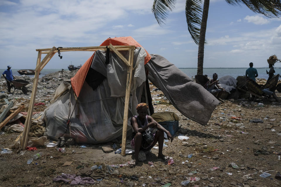 A woman sits outside her shelter in Cap-Haitien, Haiti, Thursday, July 22, 2021. The city of Cap-Haitien will hold events to honor slain President Jovenel Moïse on Thursday ahead of Friday’s funeral. (AP Photo/Matias Delacroix)