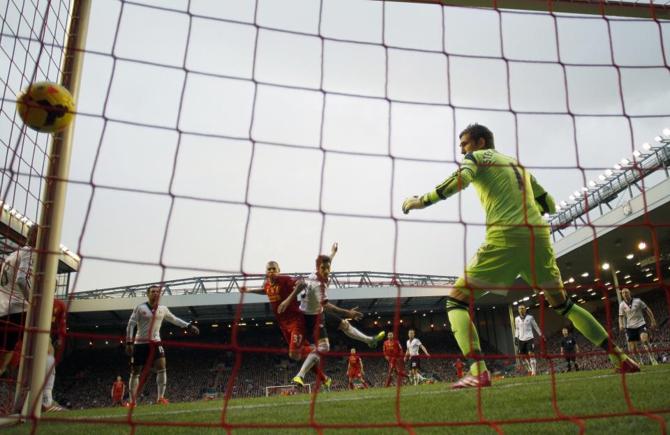 Liverpool's Martin Skrtel (L) scores a goal against Fulham during their English Premier League soccer match at Anfield in Liverpool, northern England November 9, 2013.