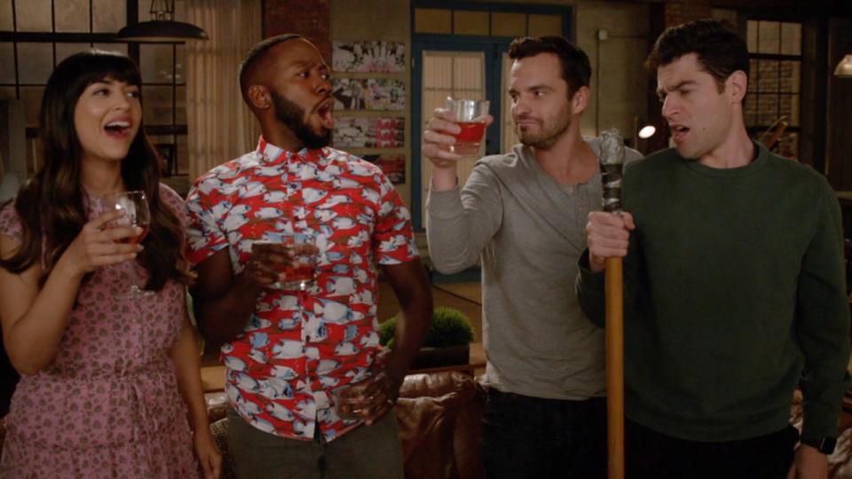 A screenshot of (from left to right) Cece, Winston, Nick and Schmidt cheers in New Girl.