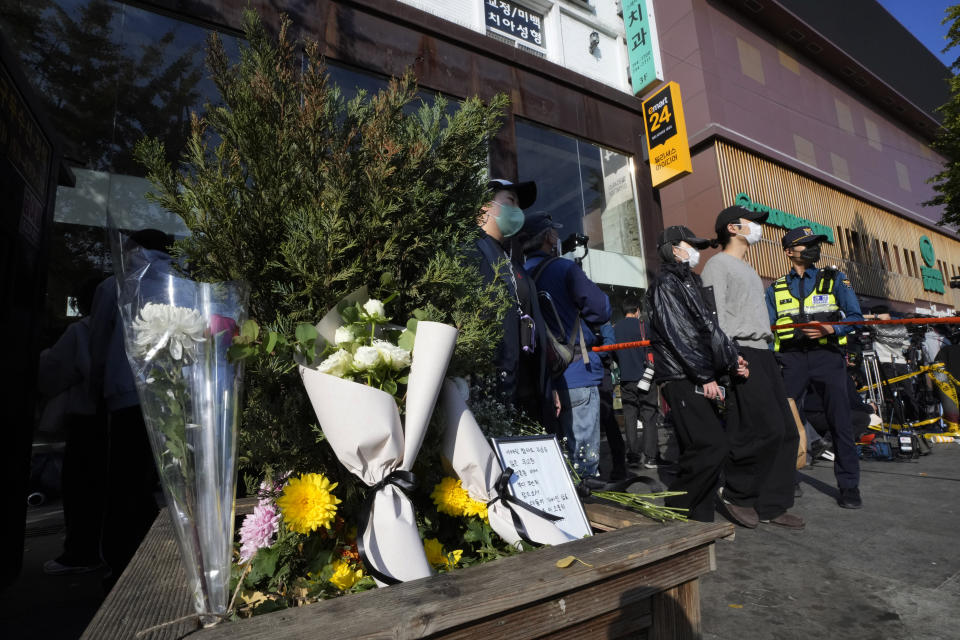 Flowers are seen near the scene of a deadly accident in Seoul, South Korea, Sunday, Oct. 30, 2022, following Saturday night's Halloween festivities. A mass of mostly young people celebrating Halloween festivities in Seoul became trapped and crushed as the crowd surged into a narrow alley, killing dozens of people and injuring dozens of others in South Korea's worst disaster in years. (AP Photo/Ahn Young-joon)