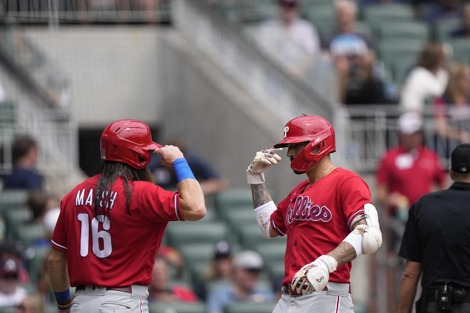 Philadelphia Phillies' Nick Castellanos (8) celebrates with Brandon Marsh (16) after hitting a two run home run in the fourth inning of a baseball game against the Atlanta Braves, Wednesday, Sept. 20, 2023, in Atlanta. (AP Photo/Brynn Anderson)