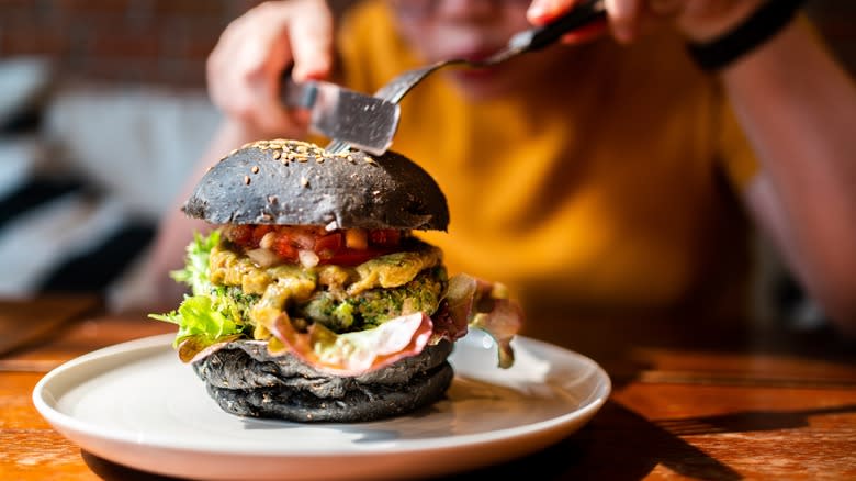 Black bun burger with toppings