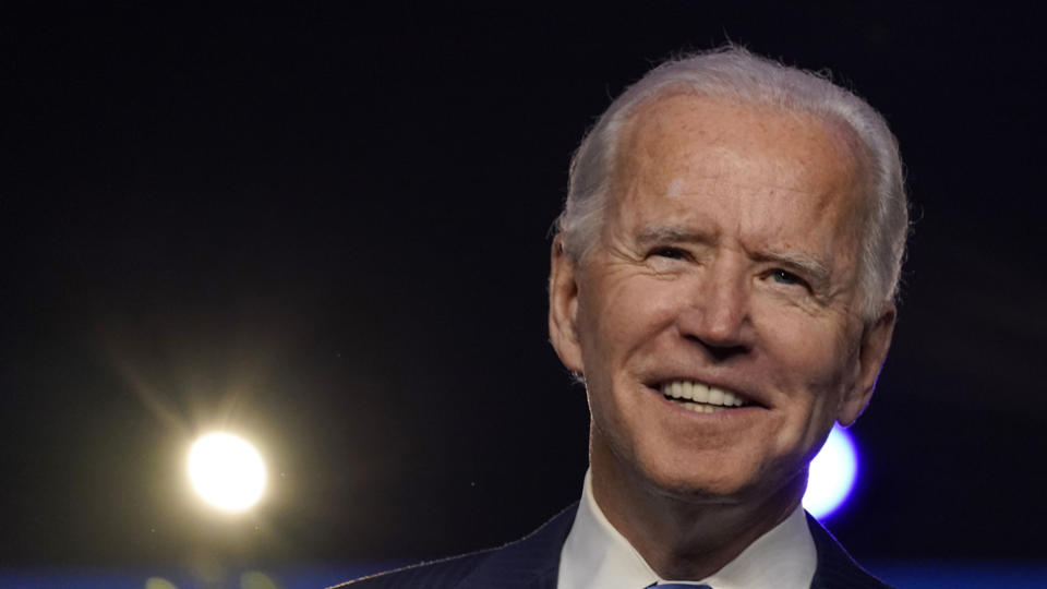 Joe Biden smiling for cameras.