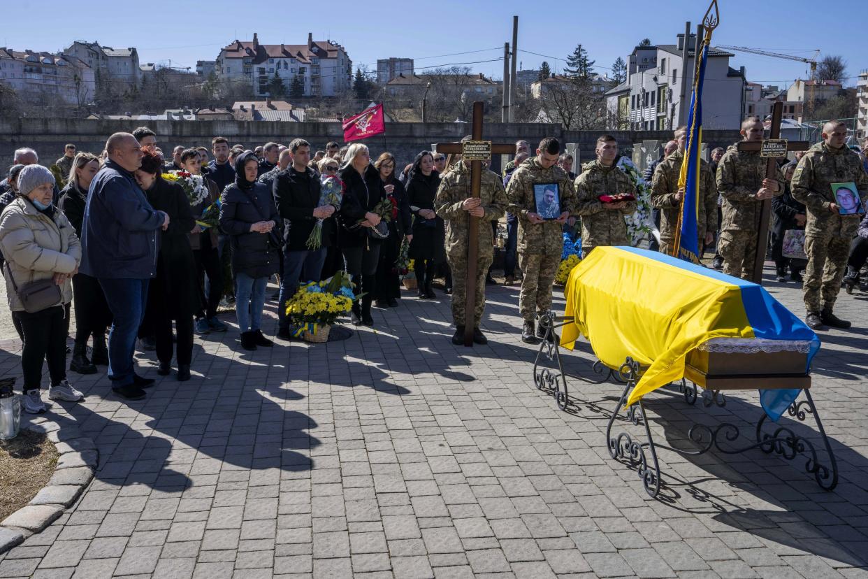 Myroslva Chernikova 54-year-old mother of 32-year-old Senior Lieutenant Pavlo Chernikov, left, mourns his death during his funeral ceremony, after being killed in action, at the Lychakiv cemetery, in Lviv, western Ukraine, Monday, March 28, 2022. The more than month-old war has killed thousands and driven more than 10 million Ukrainians from their homes — including almost 4 million from their country. (AP Photo/Nariman El-Mofty)