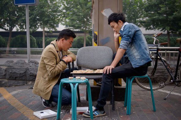 Men playing checkers in Beijing. “If legalised, polyandry would be a perfect solution for satisfying the sexual needs of 30 million single men. Photo: Ed Jones/Getty