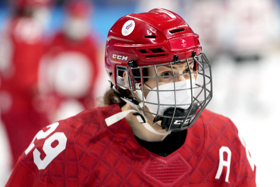 Russian Olympic Committee's Alexandra Vafina wears a COVID mask under her hockey mask as she warms up for a preliminary round women's hockey game against Canada at the 2022 Winter Olympics, Monday, Feb. 7, 2022, in Beijing. (AP Photo/Petr David Josek)