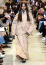 <p>Campbell struts down the Burberry runway wearing a monochromatic look and flip-flops.</p>