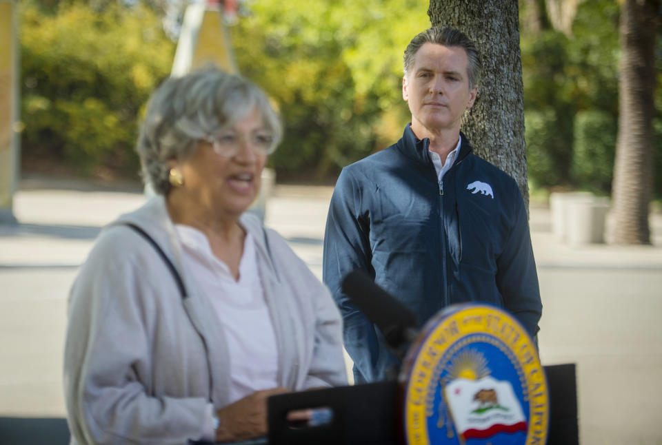 California Air Resources Board chair Mary Nichols, left, speaks as California Gov. Gavin Newsom listens at a press conference on Wednesday, Sept. 23, 2020, at Cal Expo in Sacramento where he announced an executive order requiring the sale of all new passenger vehicles to be zero-emission by 2035, a move the governor says would achieve a significant reduction in greenhouse gas emissions. California would be the first state with such a rule, though Germany and France are among 15 other countries that have a similar requirement. (Daniel Kim/The Sacramento Bee via AP, Pool)