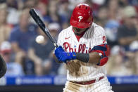 Philadelphia Phillies' Jean Segura is hit by a pitch from Washington Nationals' Joe Ross during the fifth inning of a baseball game, Monday, July 26, 2021, in Philadelphia. (AP Photo/Laurence Kesterson)