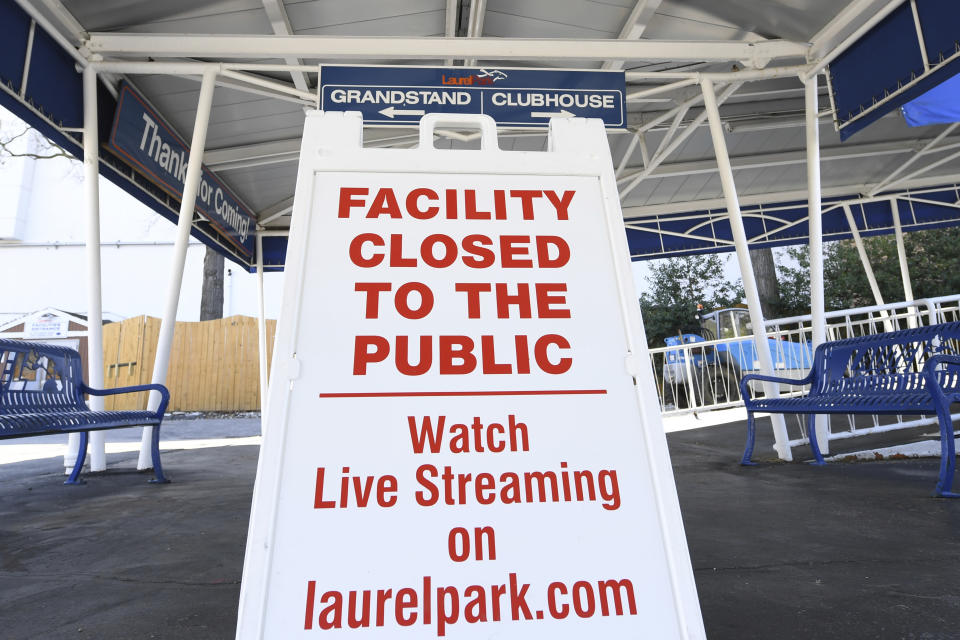 A closed to the public sign sits outside of the Grandstand at Laurel Park Race Track, Saturday, March 14, 2020, in Laurel, Md. The track is closed to the public due the coronavirus outbreak. (AP Photo/Terrance Williams)