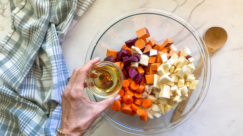 adding oil to vegetables