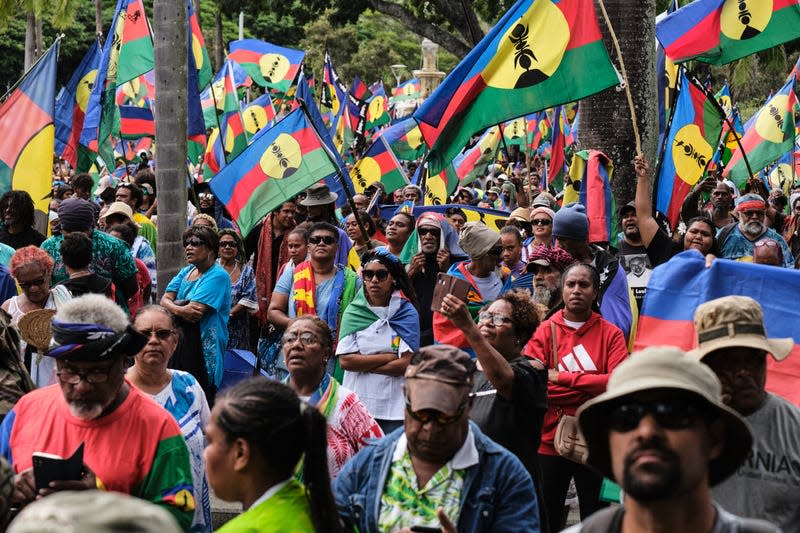 Protesters wave flags of the Socialist Kanak National Liberation Front (FLNKS) during a demonstration against the enlargement of the electorate for the forthcoming provincial elections in New Caledonia, in Noumea, on April 13, 2024. - Photo: Theo Rouby / AFP (Getty Images)