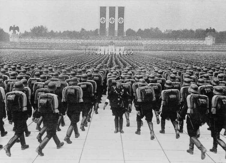 <span class="caption">Members of the SS marching in formation on Nazi Party Day, Nuremberg. Germany, September 1937.</span> <span class="attribution"><span class="source">Everett Historical via Shutterstock</span></span>