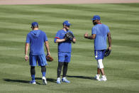 Chicago Cubs right fielder Jason Heyward, right, talks with center fielder Ian Happ, center, and left fielder Kyle Schwarber, left, during baseball practice at Wrigley Field on Friday, July 3, 2020 in Chicago. (AP Photo/Kamil Krzaczynski)