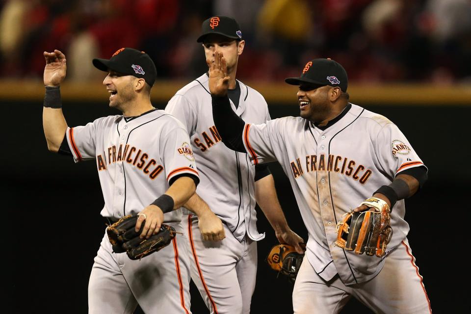 Pablo Sandoval #48, Brandon Belt #9 and Marco Scutaro #19 of the San Francisco Giants celebrate the Giants 2-1 victory in the 10th inning against the Cincinnati Reds in Game Three of the National League Division Series at the Great American Ball Park on October 9, 2012 in Cincinnati, Ohio. (Photo by Jonathan Daniel/Getty Images)