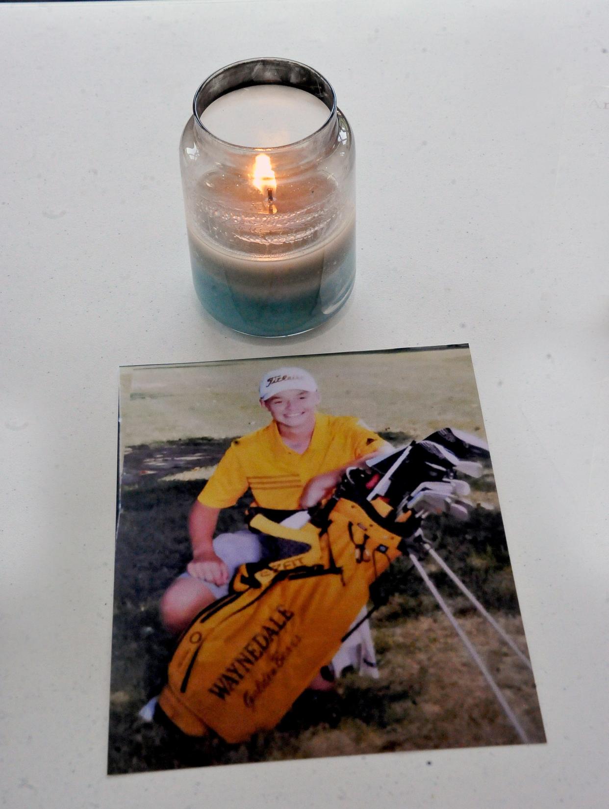 A photo of Deven "Deegan" Bee, with a candle in his memory, sat on a table at the Fredericksburg Presbyterian Church Friday. Waynedale High School, where Bee attended, set up the space at the church to provide "an opportunity for everyone to come together" following Bee's Wednesday death.