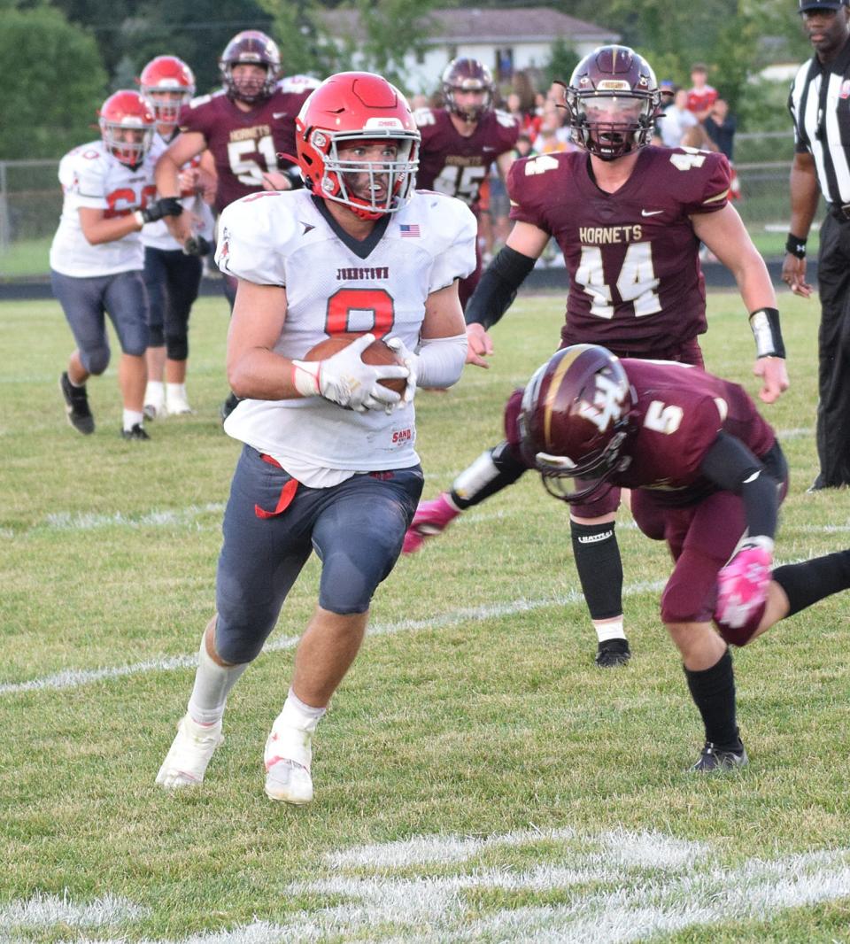 Johnstown senior Garrett Grinstead turns upfield after catching a pass against Licking Heights in Week 1. Grinstead also made a team-high six tackles for the Johnnies in the 42-21 loss.