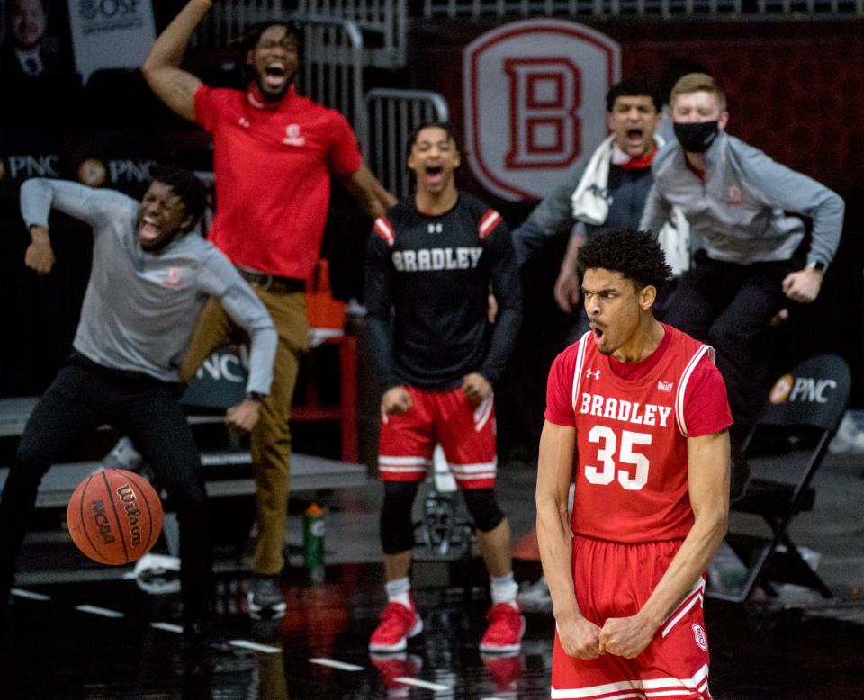 Bradley’s Darius Hannah (35) and the Braves bench celebrate his slam dunk in the final seconds to seal a 67-61 victory over Drake on Saturday, Feb. 27, 2021 at Carver Arena in Peoria.