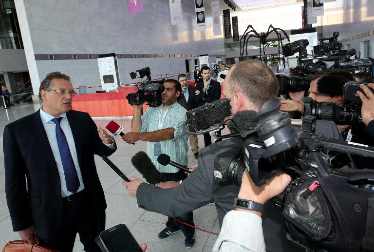 FIFA Secretary General Jerome Valcke (L) speaks to the press as he arrives for a meeting in Doha on February 24, 2015 with the FIFA taskforce