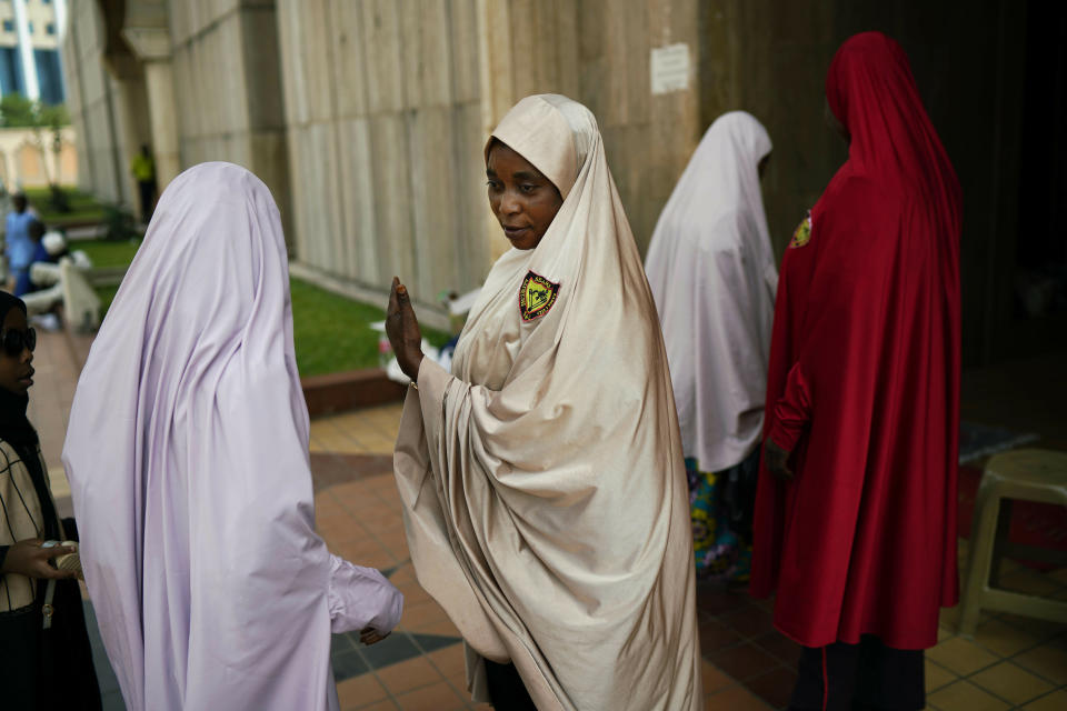 A Nigerian woman attending Friday prayers at the central mosque is security checked a day prior to the election, in Abuja, Nigeria, Friday Feb. 15, 2019. Nigeria surged into the final day of campaigning ahead of Saturday's election, as President Muhammadu Buhari made one last pitch to stay in office while top challenger Atiku Abubakar shouted to supporters: "Oh my God! Let them go! Let them go!" (AP Photo/Jerome Delay)