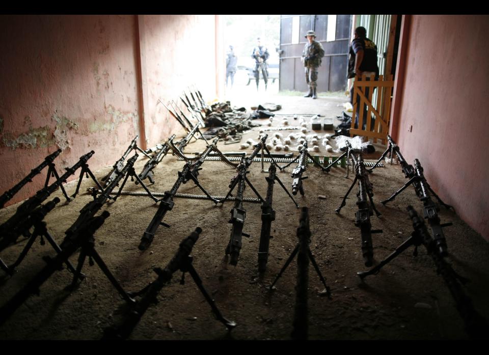 In this Dec. 21, 2010 file photo, weapons seized during a police and military raid are displayed in Coban, province of Alta Verapaz, Guatemala. In Dec. 2010, the Guatemalan military declared a month long state of siege in Alta Verapaz in hopes of reclaiming cities that have been taken over by Mexico's Zetas drug gang. (AP Photo/Rodrigo Abd, File)