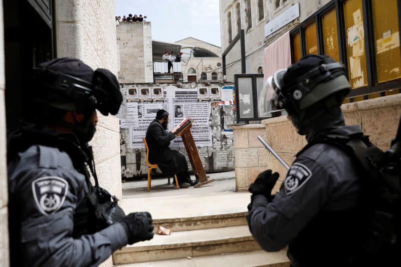 An ultra-Orthodox Jewish man prays after he was removed by Israeli police from a synagogue which they closed as they enforce restrictions of a partial lockdown against the coronavirus disease (COVID-19) in Mea Shearim neighbourhood of Jerusalem